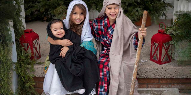 Some of the Duffy children are shown honoring the true meaning of the Christmas season. This photo and many others appear in ‘All American Christmas.'