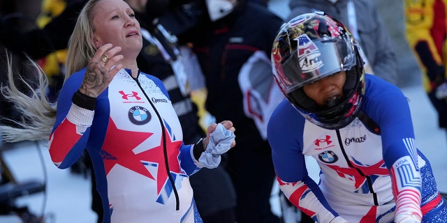 Kaillie Humphries on the left and Sylvia Hoffman of the United States react after the two women's bobsleigh world cup race in Igurus near Innsbruck, Austria, on Sunday, November 21, 2021.