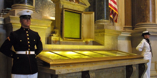 An honor guard stands next to the original copies of the Declaration of Independence, the Constitution and the Bill of Rights on July 4, 2001, at the National Archives in Washington.