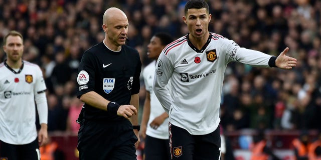 Manchester United's Cristiano Ronaldo gestures to referee Anthony Taylor during the English Premier League soccer match between Aston Villa and Manchester United at Villa Park in Birmingham, England, Sunday, Nov. 6, 2022.