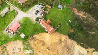 Shocking photos show farmhouse dangling off edge of cliff