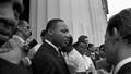 The Great March organized by A. Philip Randolph and Bayard Rustin united civil rights, religious, and labor organizations to peaceably advocate for economic and civil equality of African Americans.  Martin Luther King Jr. stands holding his speech to his chest as he interacts with reporters beside the Lincoln Memorial. (Photo by Bob Parent/Getty Images) - Fox News