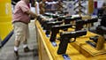 A worker sets up a display of handguns on the floor of the exhibition hall ahead of the National Rifle Association (NRA) annual meeting at the Indiana Convention Center in Indianapolis, Indiana, U.S., on Thursday, April 25, 2019. - Fox News