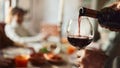 Close up of unrecognizable black man pouring red wine into a glass in dining room. - Fox News