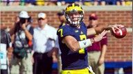 Michigan coach under fire for keeping QB in game