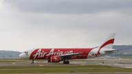 Dozens of bodies, debris found in search for AirAsia plane