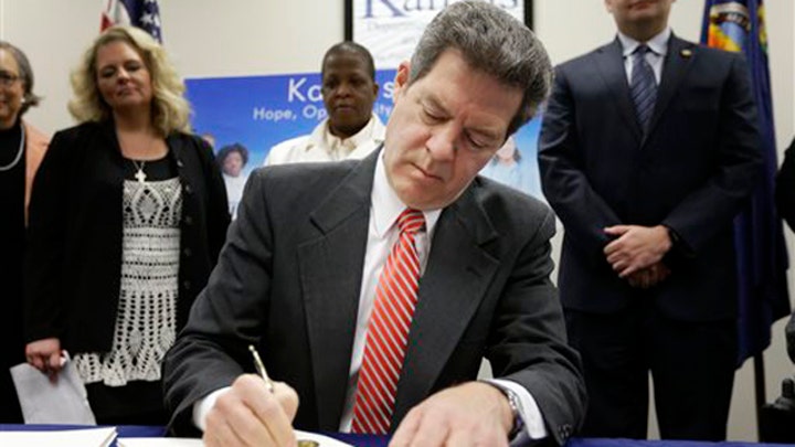 Kansas governor signs major welfare reform bill into law