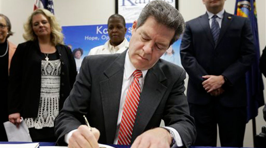 Kansas governor signs major welfare reform bill into law