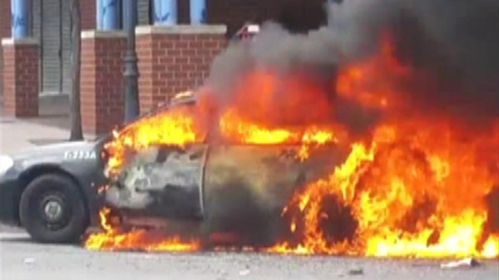 Police squad car burns amid Baltimore rioting