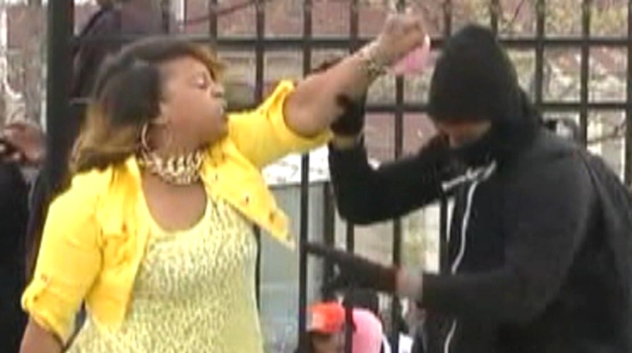 Baltimore mom smacks son for throwing rocks at police