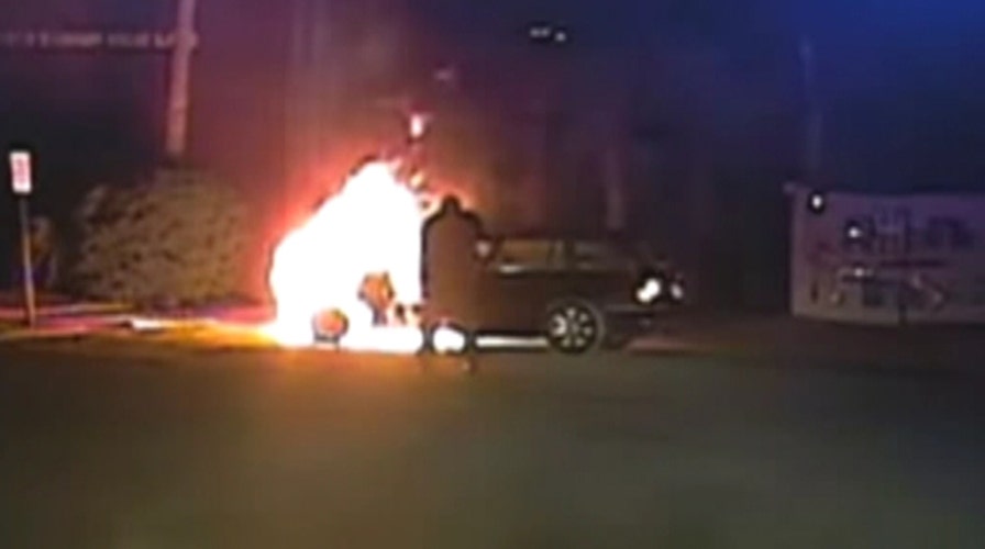 Video shows cop saving man from burning car