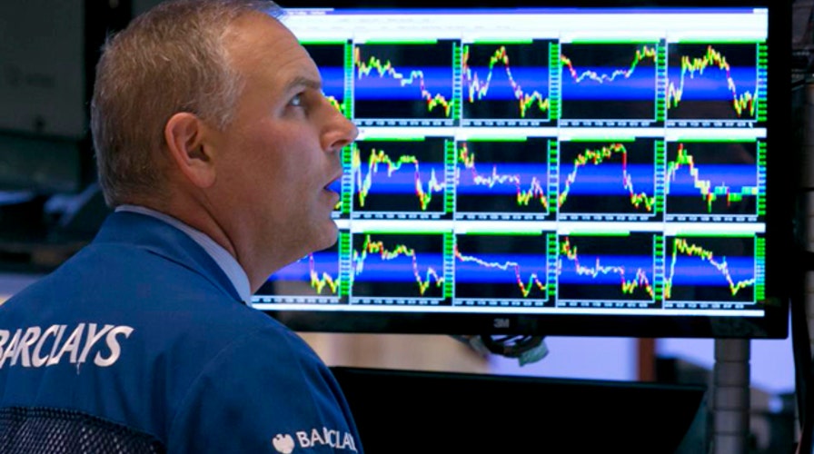 Stocks sink after Fed official warns interest rates may rise