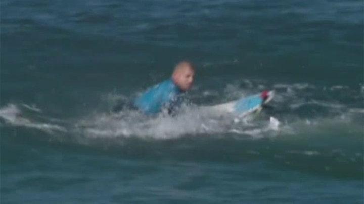 Surfing champ fights off shark attack on live TV