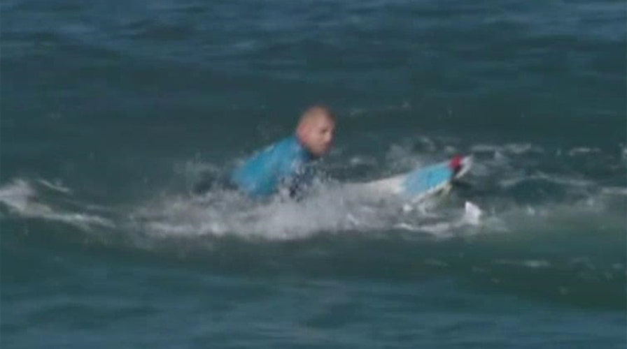 Surfing champ fights off shark attack on live TV