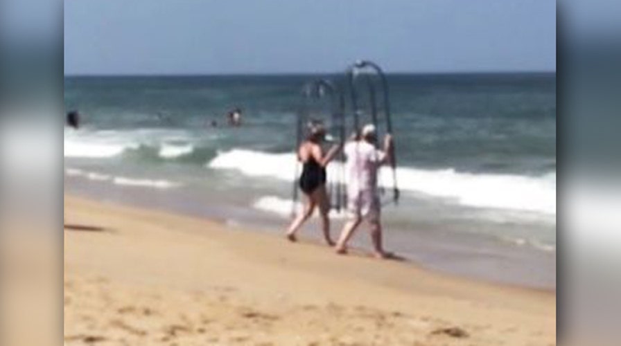Couple takes homemade shark cages for a dip