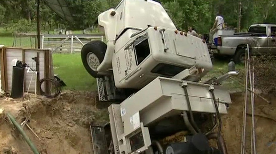 Massive sinkhole swallows utility truck