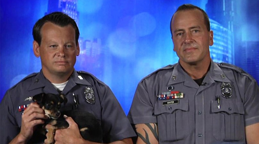 Cop surprises daughters with puppy saved from hot car