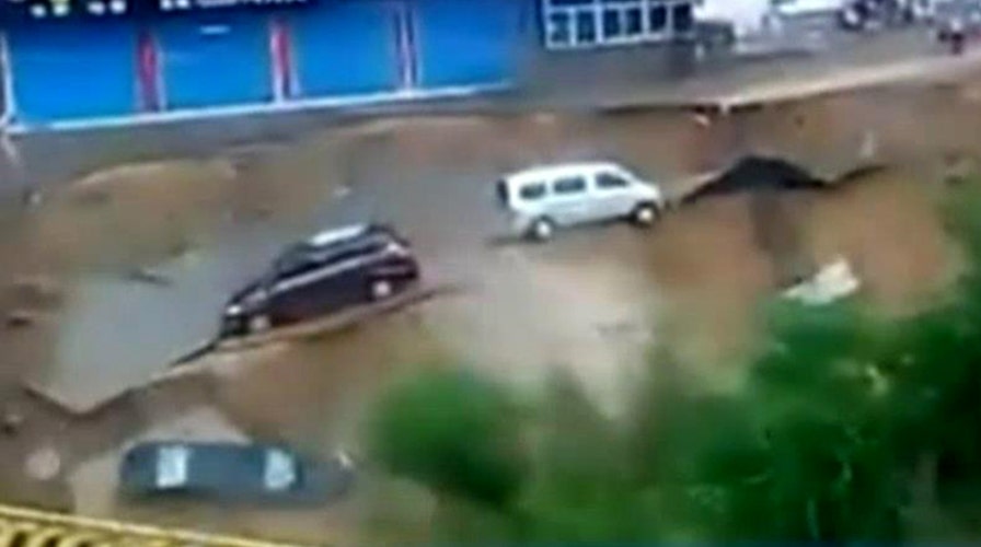 Road rips apart, cars plummet into muddy waters