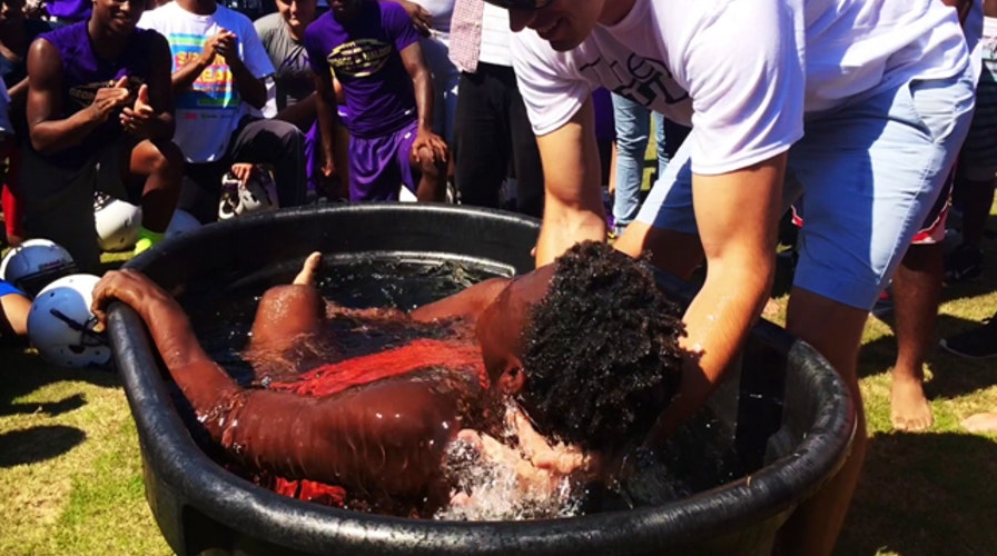 High school team baptized on football field 