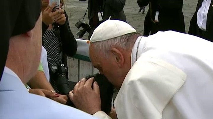 Pope Francis blesses young boy in a wheelchair