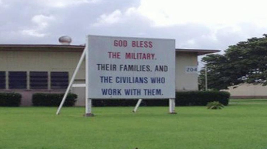 Group demands 'God bless the military' sign removed