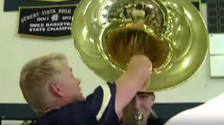 Reporter loses mic in horn during live pep rally segment
