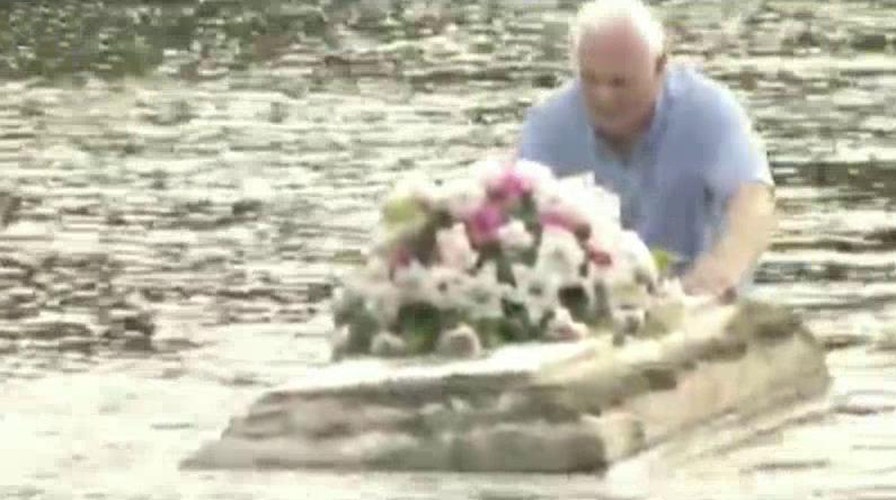 Pastor braves South Carolina floodwaters to save casket
