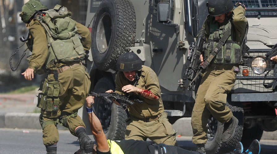 Young Palestinians attacking Israelis in the streets