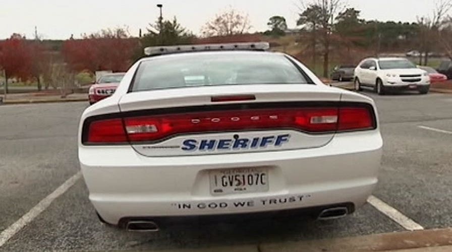 Sticky controversy over 'In God We Trust' decals