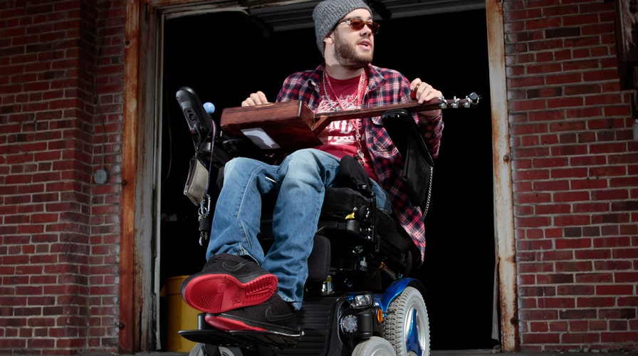 Quadriplegic defies the odds and plays the guitar again