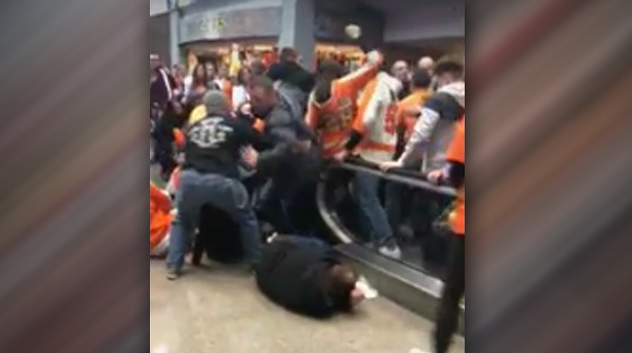 Malfunctioning escalator sends hockey fans flying