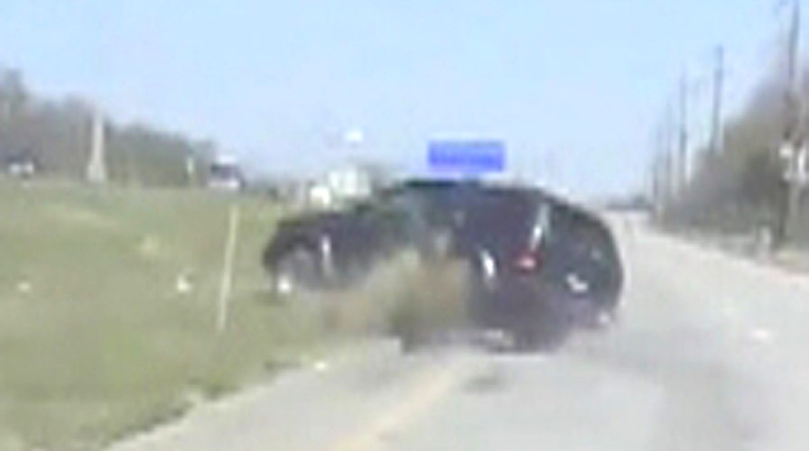 Driver thrown from flipping SUV; cop rushes to rescue