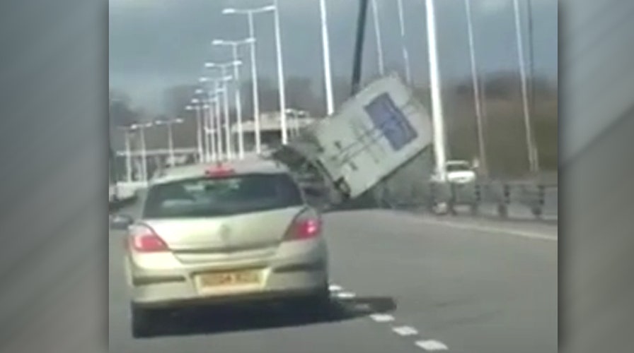 Watch high winds flip tractor-trailer on busy bridge