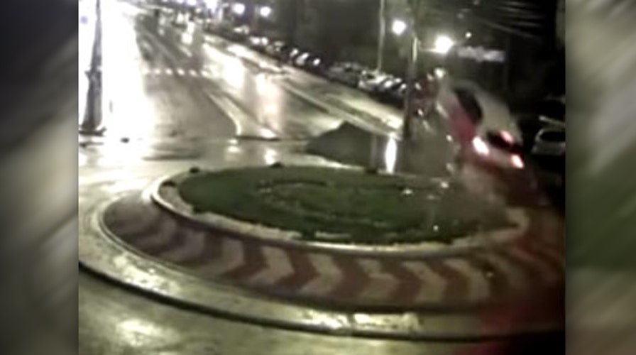 Speeding car hits traffic circle, flies through air