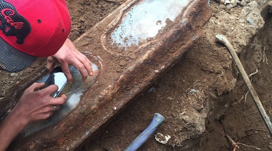 Century-old coffin with child's remains found under garage