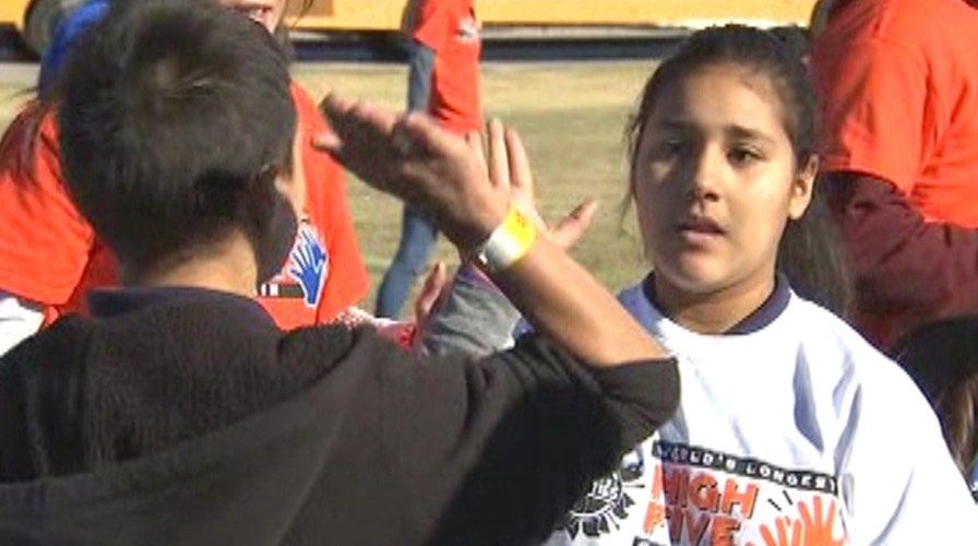 Kids look to break record for longest high-five chain