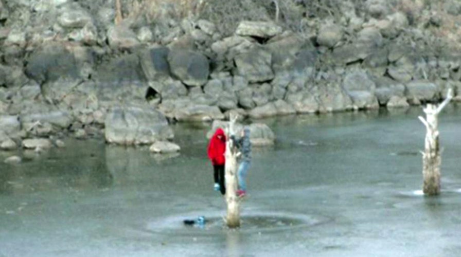 Teens trapped on icy lake cling to tree for four hours 