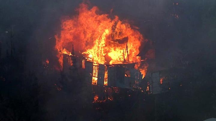 Around the World: Huge forest fire destroys dozens of homes
