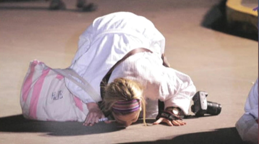 Carnival passenger kisses ground after disembarking