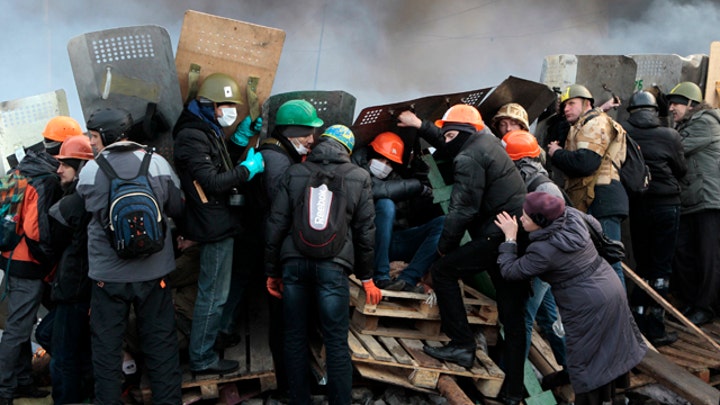 Protesters fight for position against riot police in Kiev