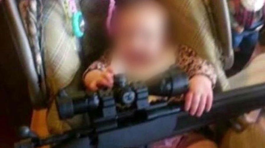 Photo of baby with rifle sparks controversy in Connecticut
