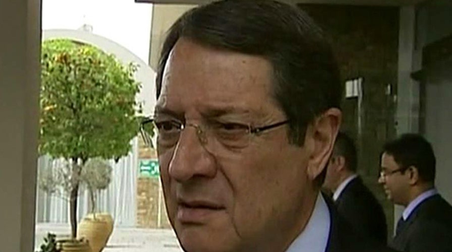 Awaiting vote on Cyprus plan to tax private bank accounts