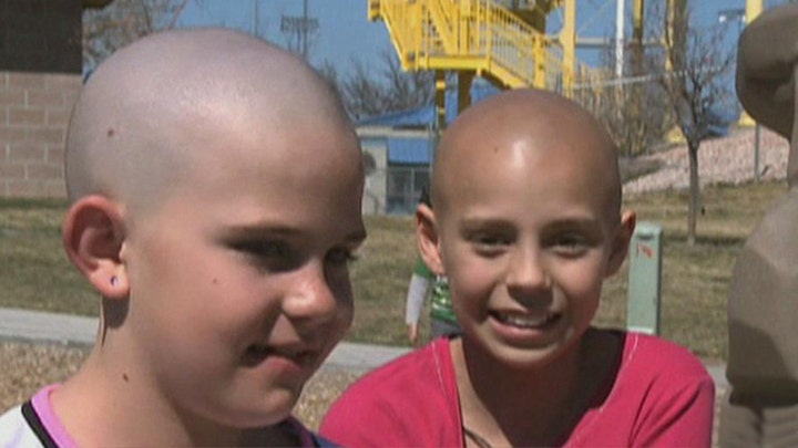 Girl who shaved head in cancer solidarity barred from school