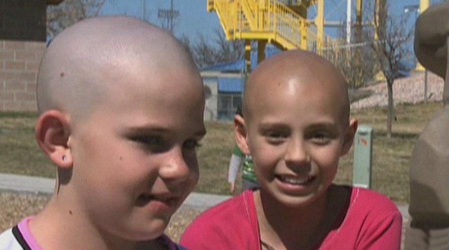 Girl who shaved head in cancer solidarity barred from school
