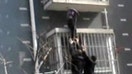 Around the World: Man scales burning building to save child