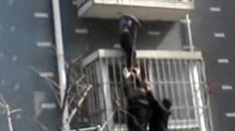Around the World: Man scales burning building to save child