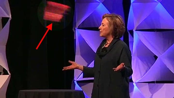 Woman throws shoe at Hillary Clinton