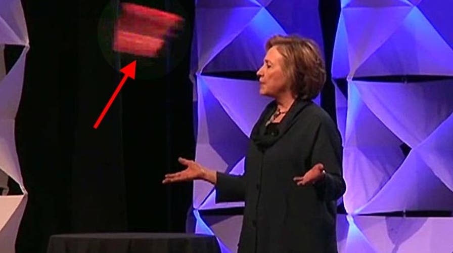 Woman throws shoe at Hillary Clinton
