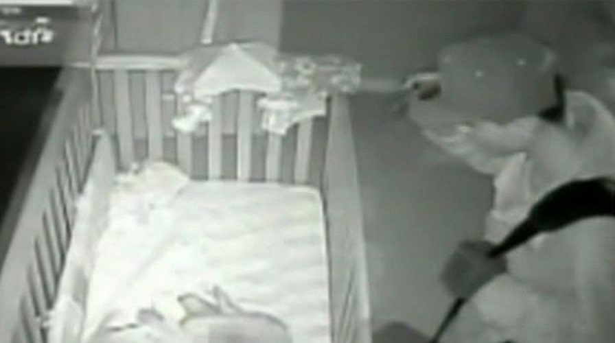 Burglar caught standing over baby's crib