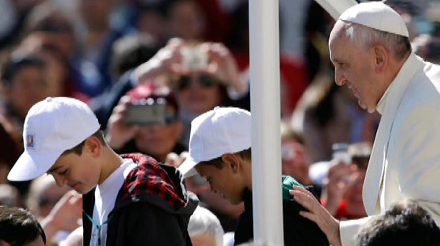 Kids catch a ride on the Pope-mobile 